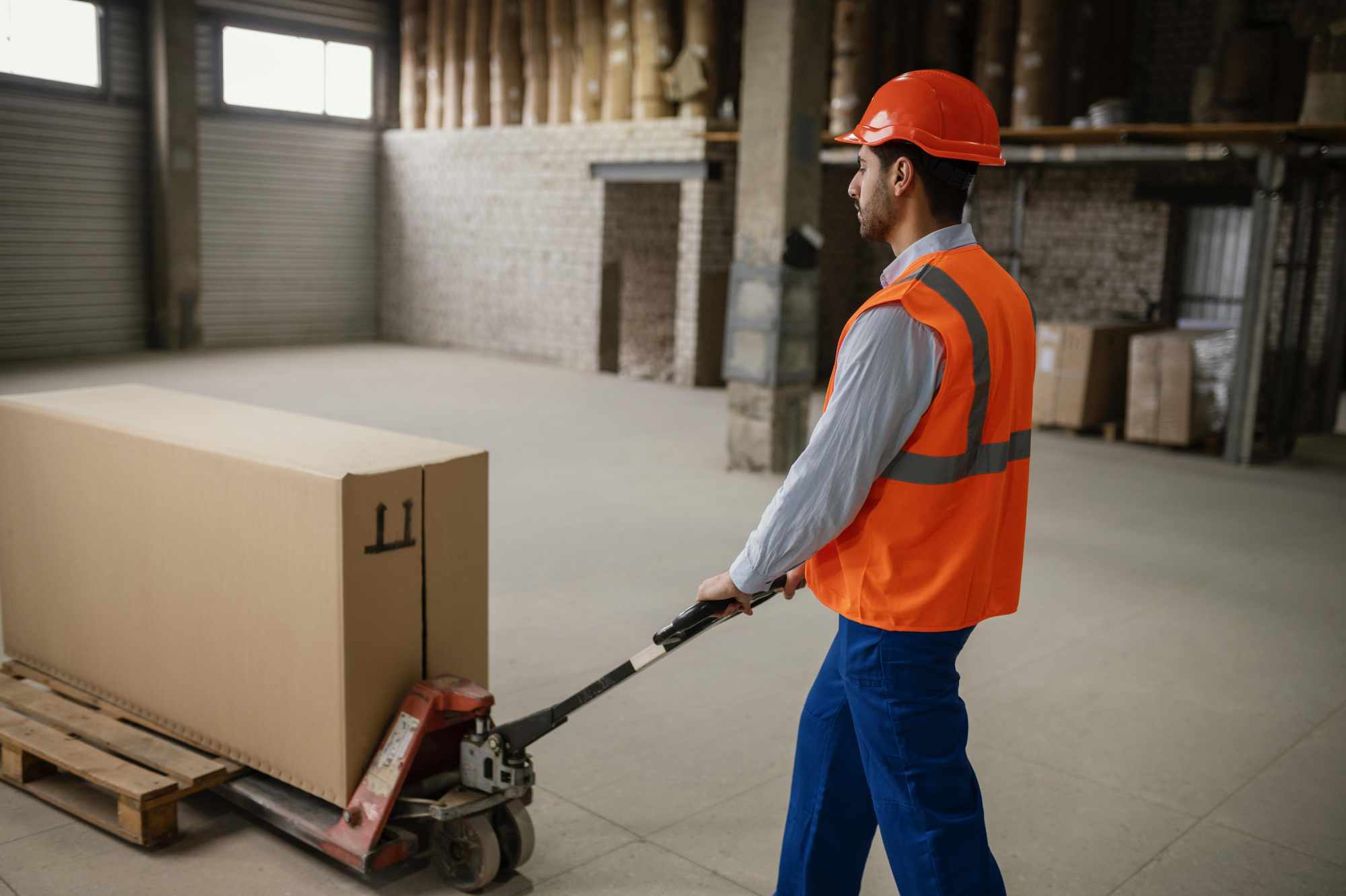 Woman carefully packing a box in a bright living room