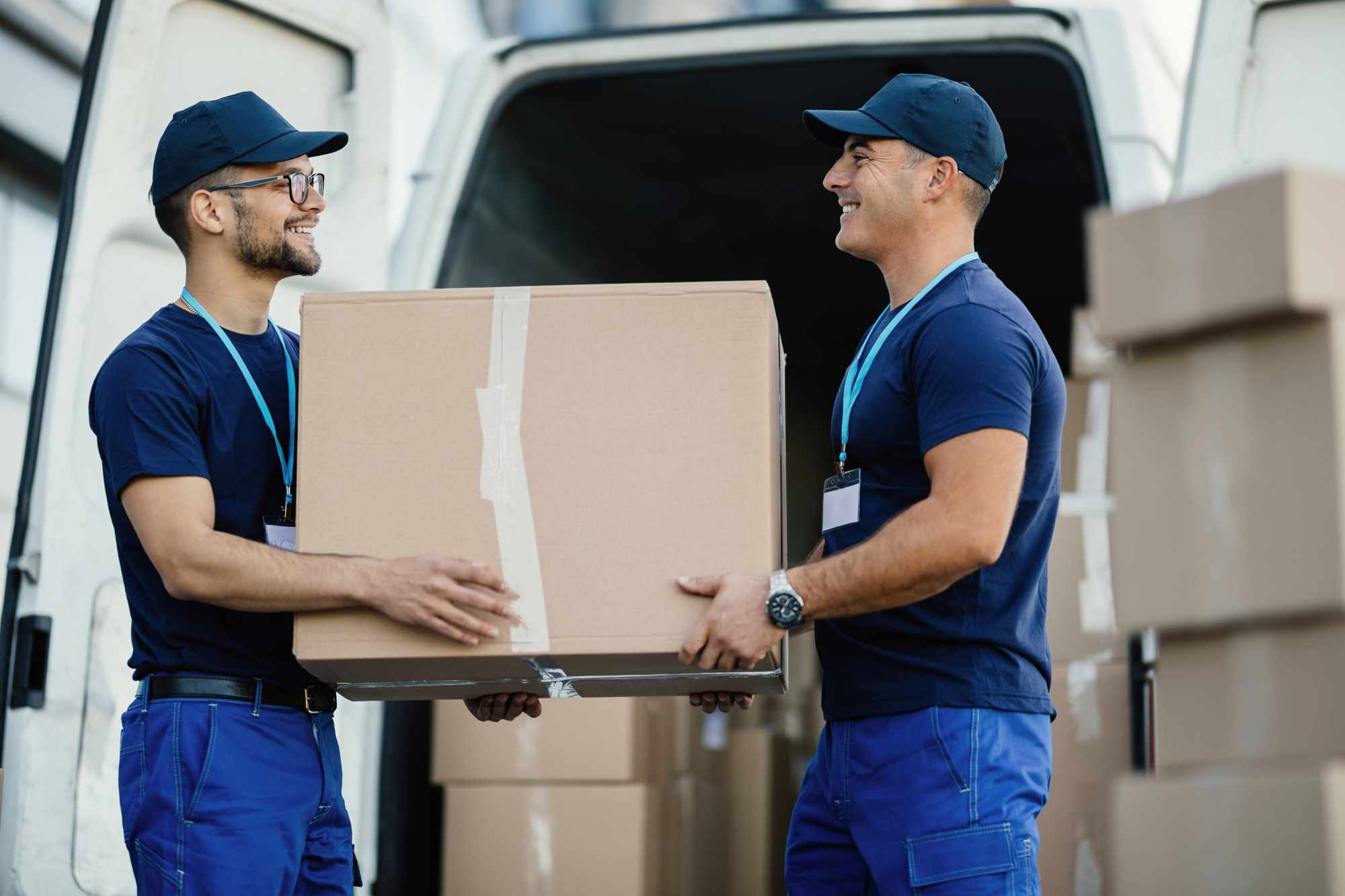 Couple carrying moving boxes ready for loading